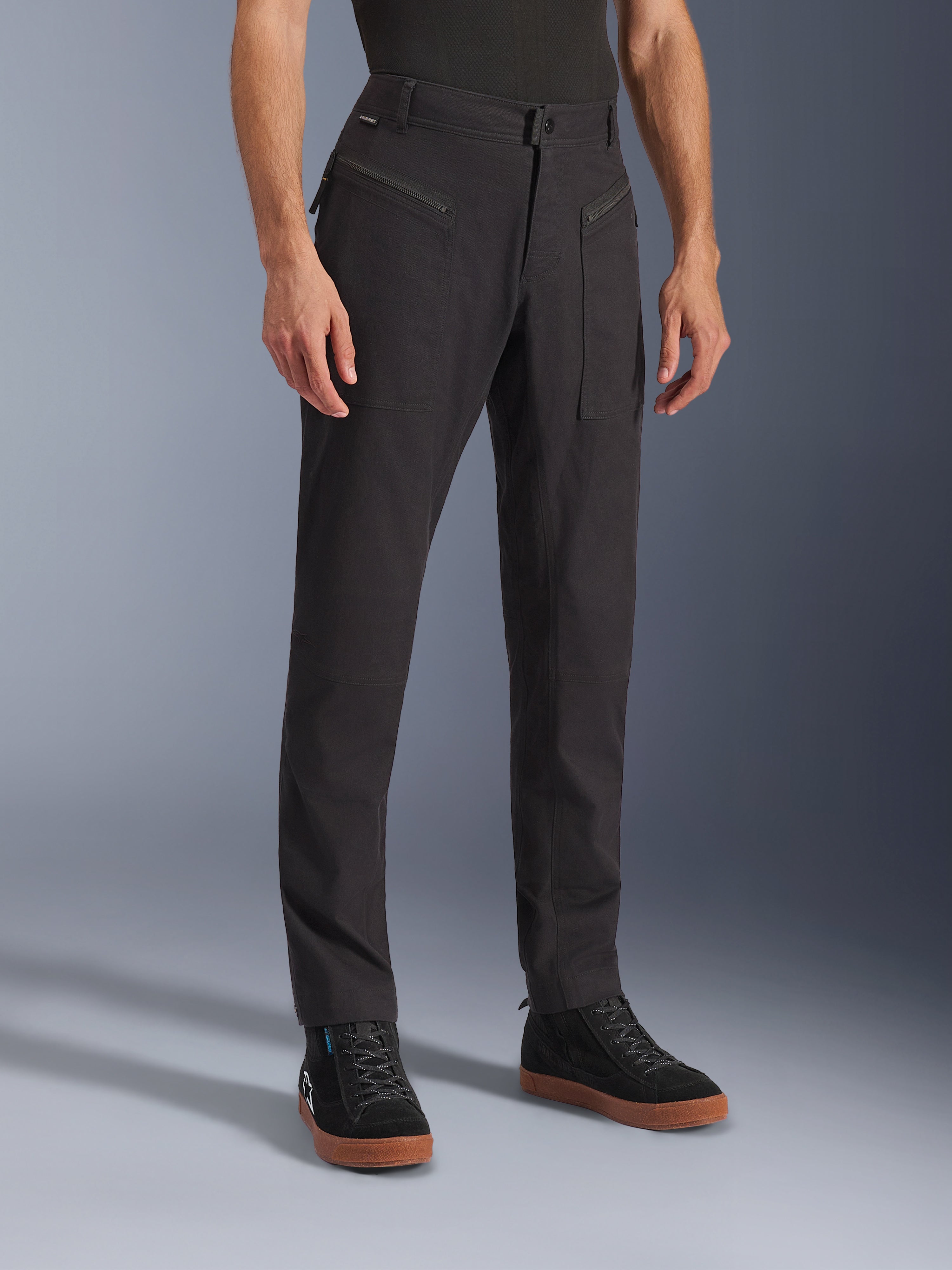 Alpinestars Flex-AST Canvas Pants, Black, Urban Motorcycle Pants, worn on model with black sneakers, featuring a heritage workwear design, stretch polycotton twill fabric, and functional zippered front pockets.