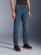Alpinestars Flex-AST 5 Denim Pants, Indigo Washed motorcycle jeans, regular tapered fit, worn with black high-top sneakers and a black shirt, casual urban riding gear featuring a classic denim appearance.