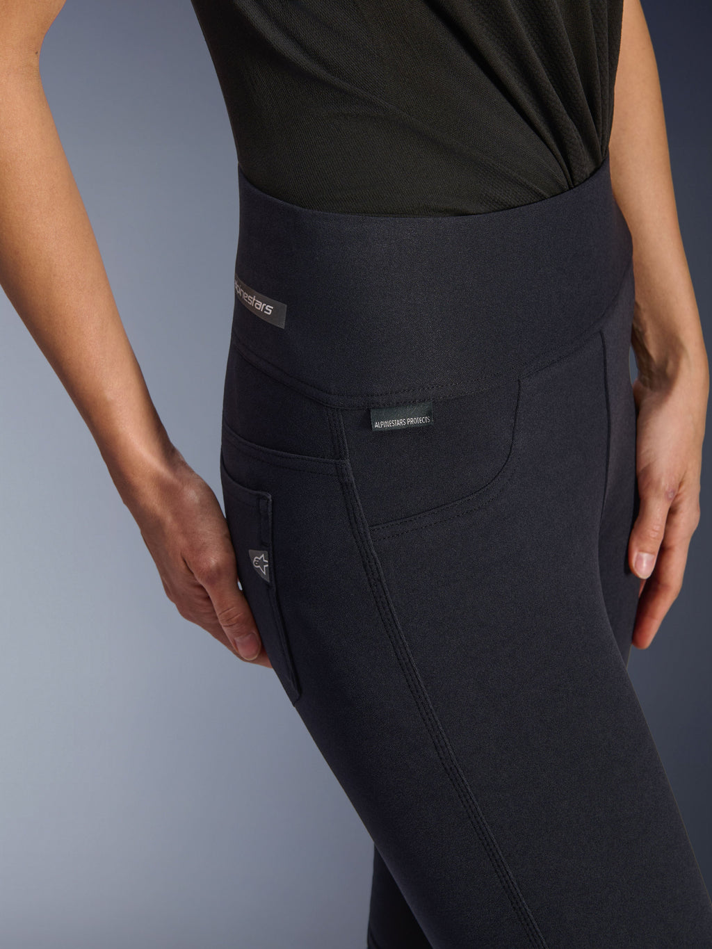 Alpinestars Woman Stella Flex-AST Leggings, Black high-waisted motorcycle pants, close-up of the hip area featuring the jacquard label, triple top-stitched side seams, and denim-inspired pocket detail, urban riding apparel for women