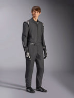 Alpinestars GP Tech V4 Suit, One-piece auto racing suit, Black and White, worn with matching racing gloves and footwear, featuring white logos on the shoulders and forearms, sleek professional design for motorsport