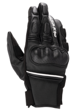 Alpinestars Phenom Leather Gloves, Black and White, short-cuff motorcycle gloves with hard knuckle protection, perforated leather details, white Alpinestars branding on the index finger, and white stripe accent at the wrist