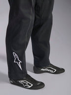 Alpinestars Kart Indoor V2 Suit, Black karting suit, close-up of lower legs and feet featuring a white Alpinestars logo on the calf, worn with matching black and white racing shoes, designed for recreational karting.