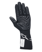 Alpinestars Tech-1 Start V4 Gloves FIA, Black Auto Racing Glove, palm view featuring grey silicone grip patterns on fingers and palm, white Astars logo on the extended cuff, FIA certification label, professional motorsport gear