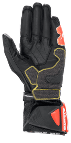 Alpinestars GP Tech V2-handskar, Svart Vit och Röd Fluo, vy av handflatan som visar svart läderkonstruktion med gula kontrastsömmar, skyddande DFS-manschett med röda detaljer, professionell racingutrustning för motorcykel