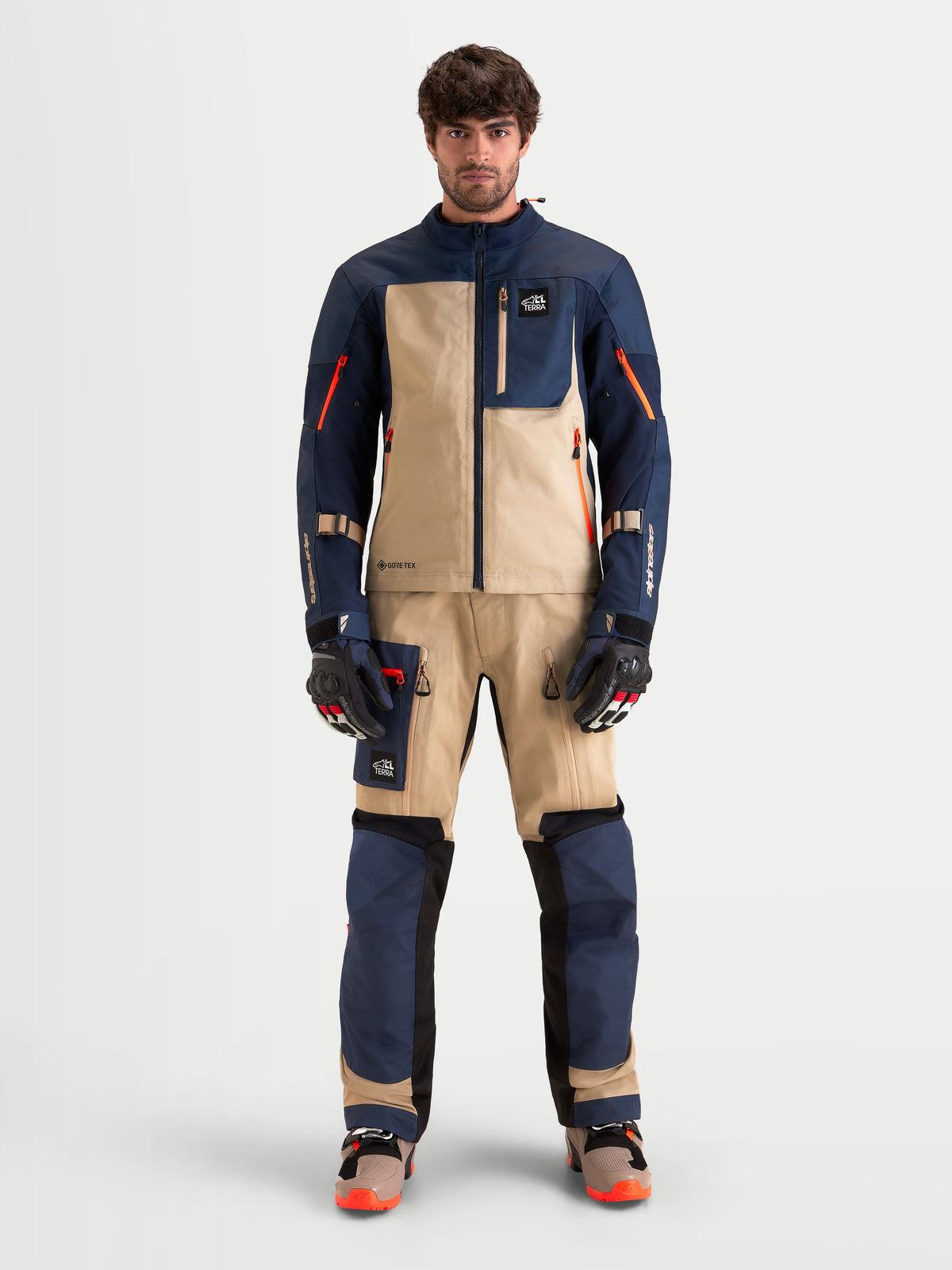 Alpinestars Arenis Gore-Tex Gear Set, men's adventure touring motorcycle jacket and pants in night navy and aluminum, front view on a model wearing matching technical riding apparel and gloves.