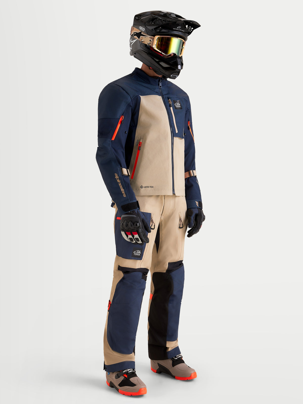 Alpinestars Arenis Gore-Tex Gear Set, men's adventure touring motorcycle jacket and pants in night navy and aluminum, full-length profile view on a model wearing matching gear and helmet, AA certified waterproof all-terrain riding apparel.