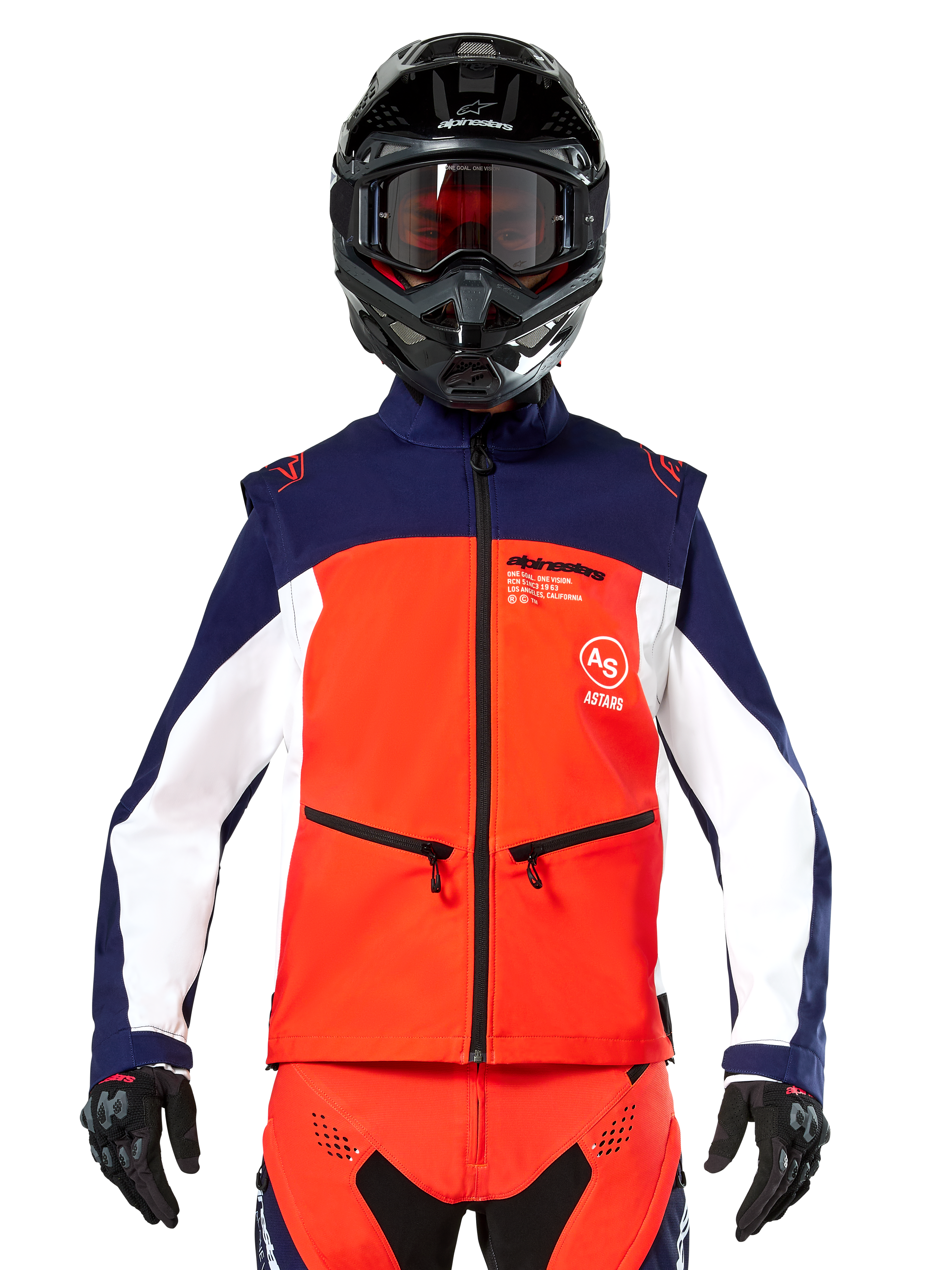 Alpinestars Lite-Dura Softshell Jacket in Navy, Hot Orange, and White, front view on a rider wearing a black helmet and goggles, featuring a color-blocked technical design with zippered hand pockets and Alpinestars branding, versatile gear for enduro and off-road riding