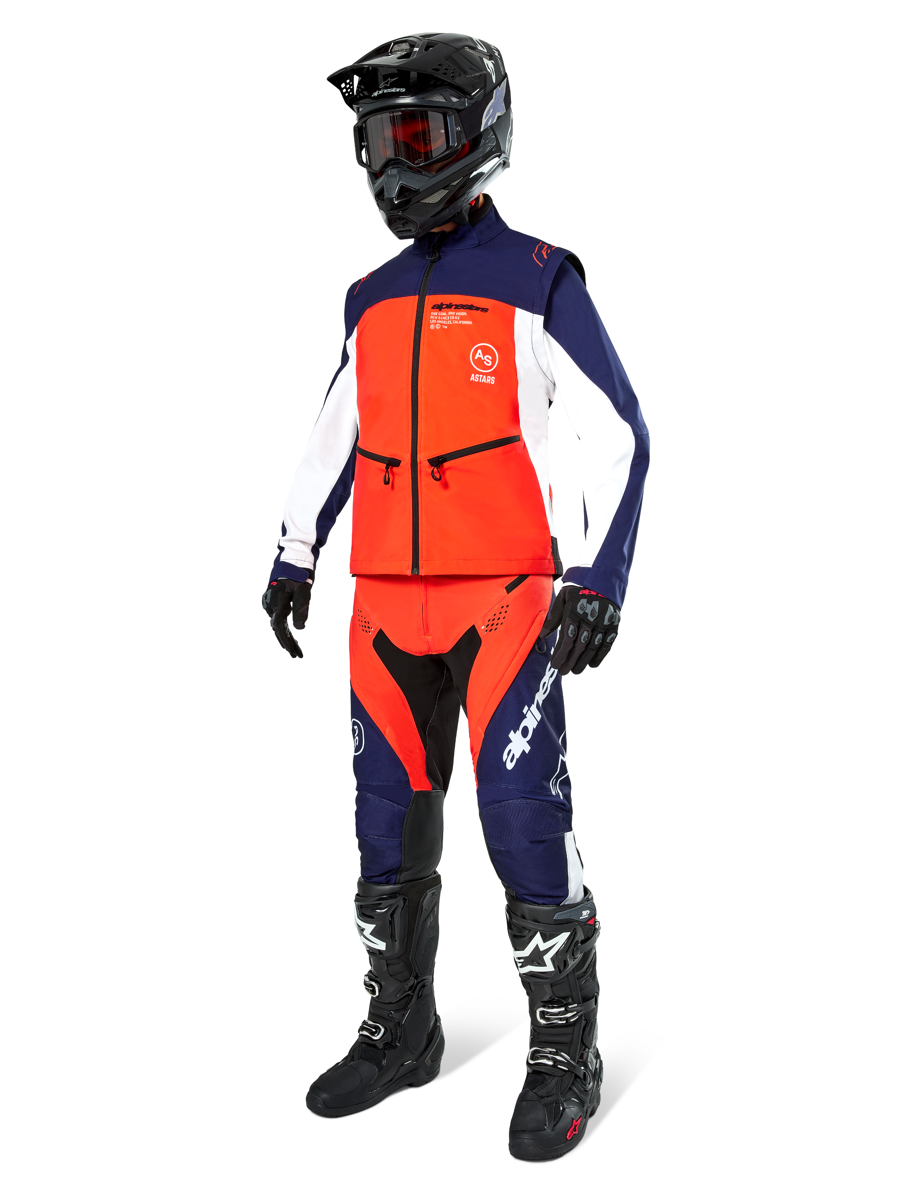 Motocross rider wearing the Alpinestars Lite-Dura Softshell Jacket in Navy Hot Orange and White, complete with matching off-road pants, black helmet with goggles, and black racing boots, coordinated enduro gear set