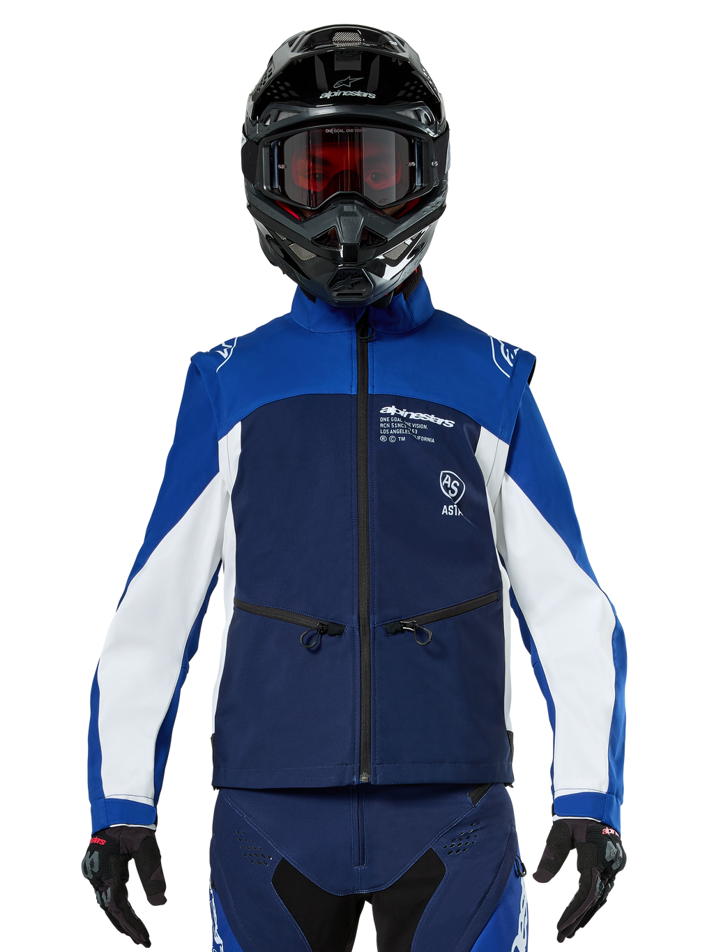 Motocross rider wearing the Alpinestars Lite-Dura Softshell Jacket in Navy Bright Blue White, front view, paired with a black helmet and red-tinted goggles, featuring a technical windproof design with zippered pockets and white accents for off-road enduro riding