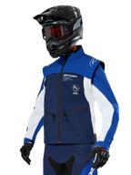 Alpinestars Lite-Dura Softshell Jacket, Navy, Bright Blue and White, Off-Road Enduro Jacket, worn with black helmet and red-tinted goggles, sporty color-block design with multiple zippers and brand logos, durable textile for motocross and trail riding