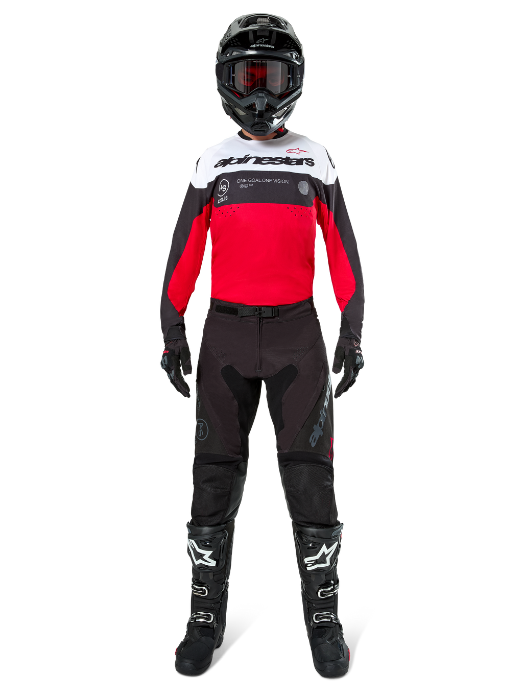 Motocrossförare iförd Alpinestars Pro-Dura-byxor i svart och Magnet, kombinerat med röd, vit och svart tröja, svart hjälm och svarta stövlar, komplett utrustning för terrängkörning, slitstark och lätt design för endurokörning