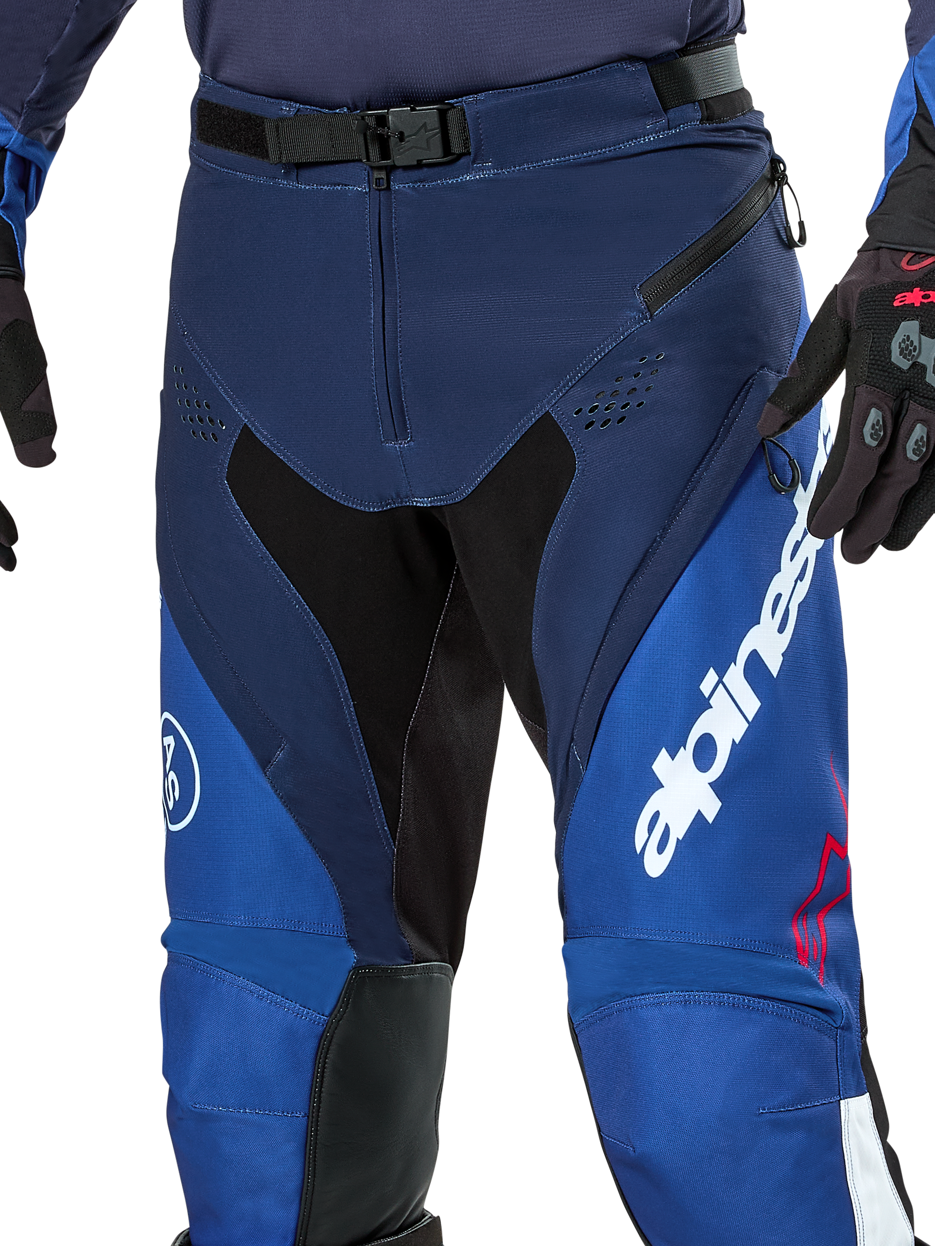 Alpinestars Pro-Dura Pants, Enduro and Motocross Pants, Navy Bright Blue and White, close-up view showing the SX2 magnetic buckle waist closure, zippered thigh vents, and durable stretch panels with bold white branding.
