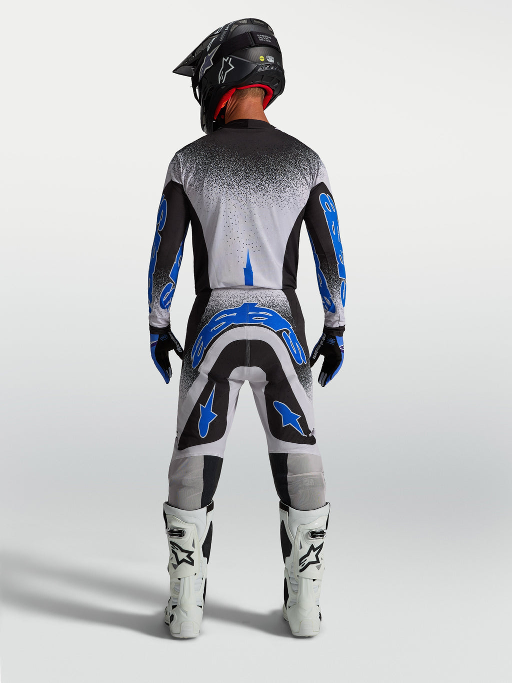 Alpinestars Supertech Hiten AFD byxor, blå och vita motocrossbyxor för herrar, atletisk vy bakifrån med racingpassform