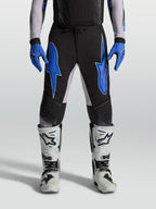 Alpinestars Supertech Hiten AFD-byxor, svarta och blå motocrossbyxor i lätt stretch-ripstop för racing.