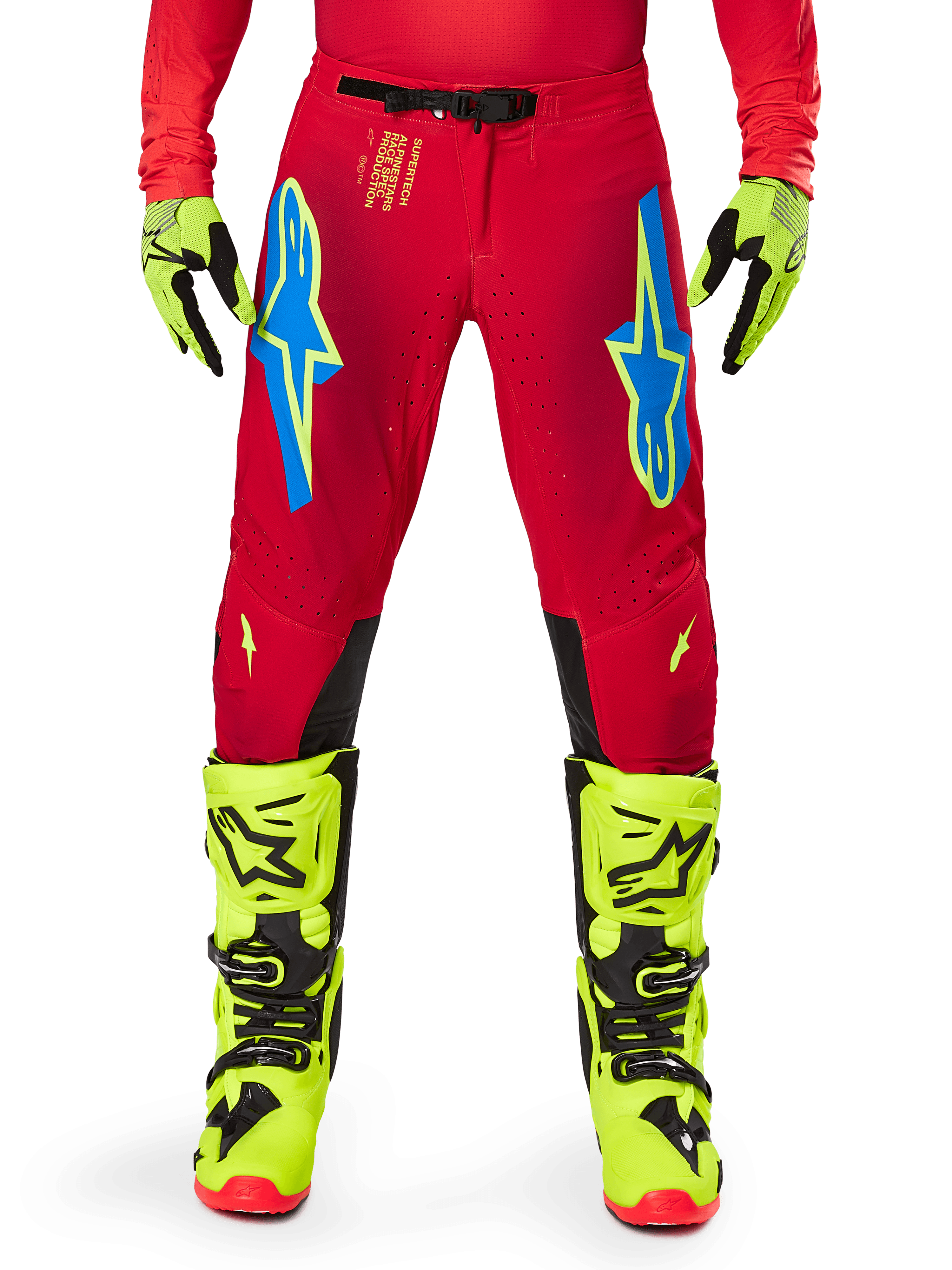 Alpinestars 2025 Supertech Maker Pants, Motocross Pants, Bright Red and Yellow Fluo, featuring blue Astars logos on the thighs, ventilated perforations, and black inner knee panels, worn with matching yellow fluo boots and gloves