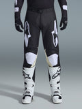 Alpinestars 2026 Racer Air Riway-byxor, motocrossbyxor, svarta och vita, med framträdande vita Alpinestars-logotyper på låren och knäpanelerna, kombinerat med vita och svarta motocross-stövlar och svarta handskar, atletisk race-fit-design för terrängkörning