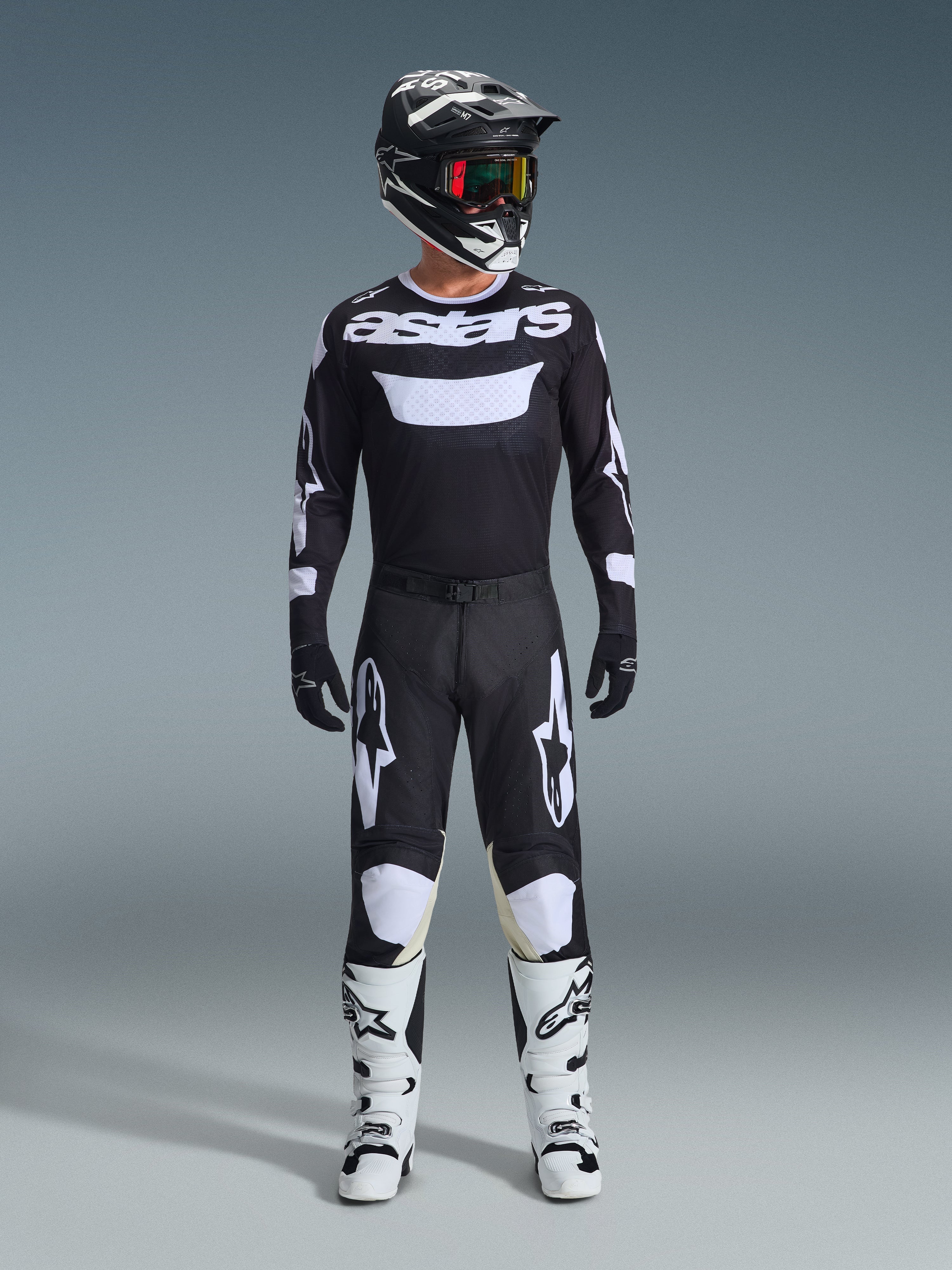 Alpinestars 2026 Racer Air Riway Gear Set, complete motocross outfit, black and white, featuring a black jersey with white 'astars' branding, matching pants with white knee panels, white boots with black buckles, and a black helmet with red-tinted goggles, professional off-road racing gear.