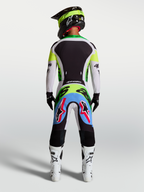 Alpinestars Supertech Dyna Pants, motocross gear in Light Lilac and Green Fluo, rear view on a rider wearing a full race kit.
