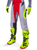 Alpinestars 2025 Techstar Melt byxor, motocrossbyxor, klarröda och grå, med neongul grafik på sidorna och svarta knäpaneler, kombinerat med matchande neongula stövlar och handskar, designade för tävlingsprestanda vid terrängkörning