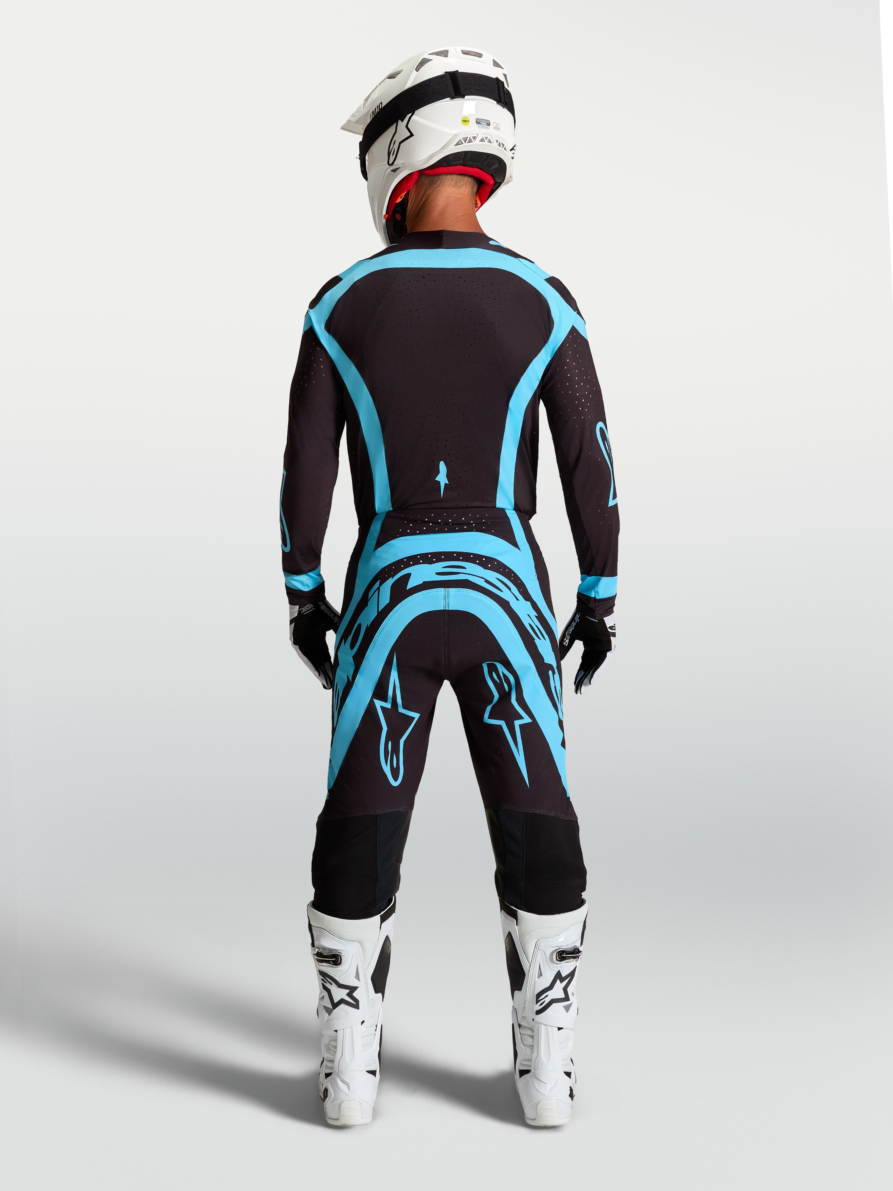 Alpinestars Supertech Vesta byxor, svarta och turkosa motocrossbyxor med atletisk passform, professionell utrustning.