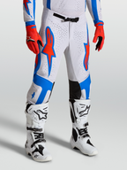 Alpinestars Supertech Vesta byxor, vita och röda motocrossbyxor med blå stjärngrafik, atletisk tävlingspassform för herr.