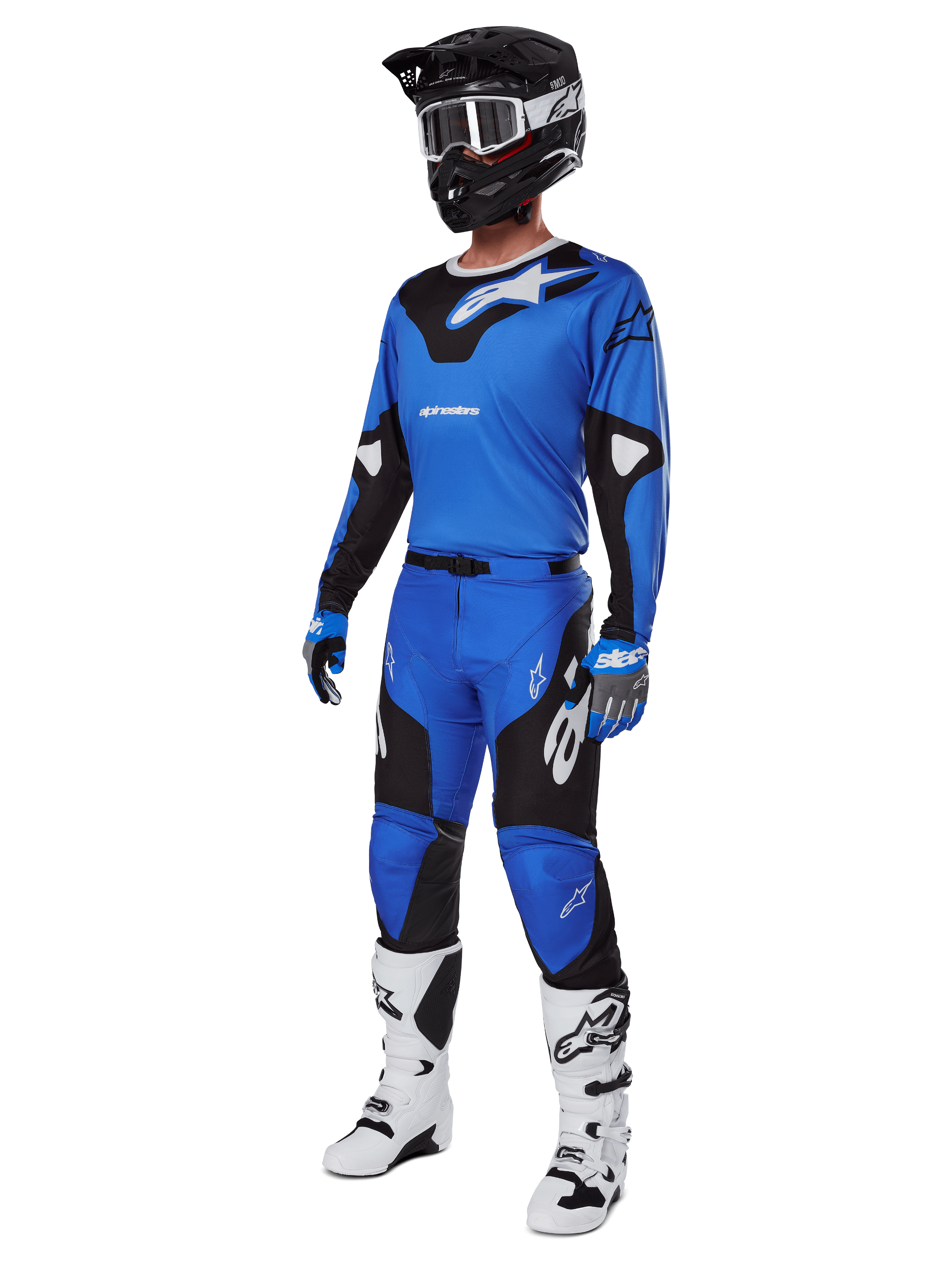 Motocross rider wearing complete racing gear, featuring Alpinestars 2025 Racer Veil Pants in Blue and Black, matching blue jersey with white accents, black helmet with white goggles, white and black boots, and blue gloves, coordinated outfit for off-road racing