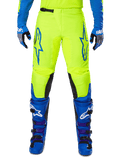 Alpinestars 2025 Fluid Haul Pants, Motocross Pants, Bright Yellow and Blue, worn with matching gloves and boots, featuring black inner knee panels, bold blue branding on the thighs, and a sporty ergonomic design.