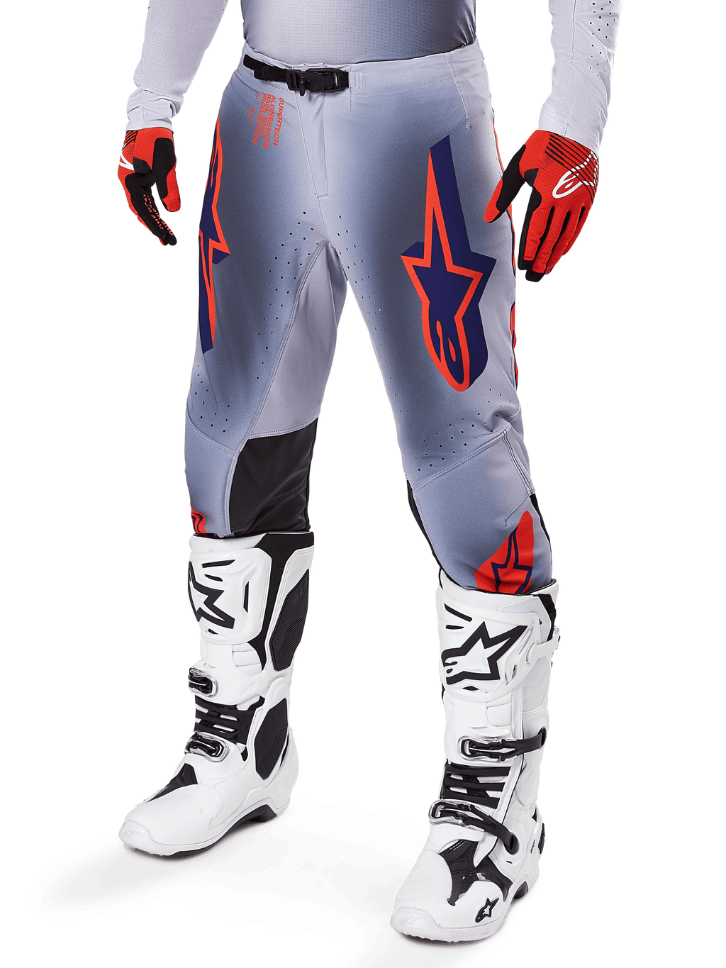 Alpinestars 2025 Supertech Lipan Pants, Motocross Pants, Gray and Orange Fluo, featuring navy star designs and black inner knee panels, worn with red-orange gloves and white boots, professional off-road racing gear