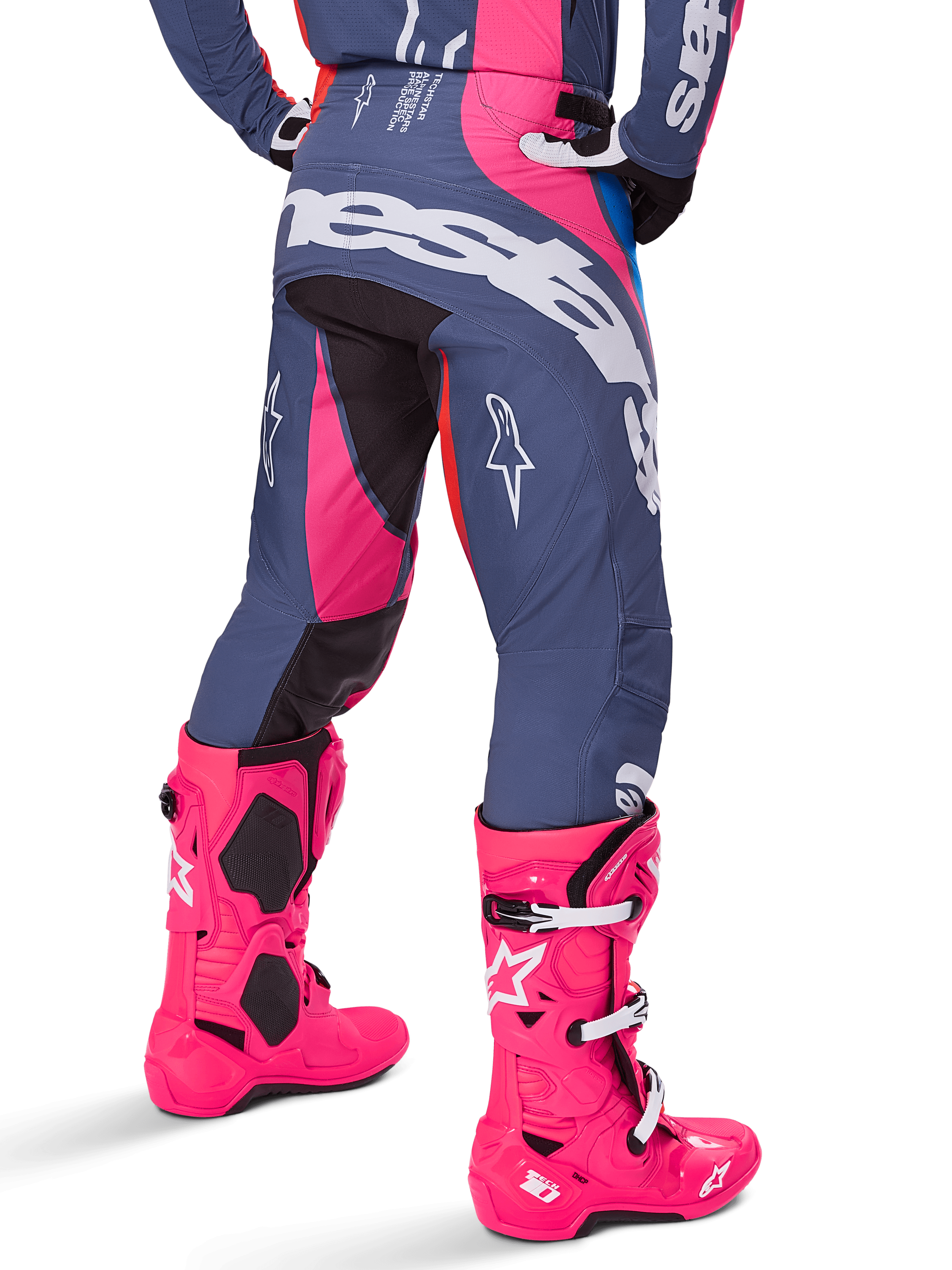 Alpinestars 2025 Techstar Dreem-byxor, motocrossbyxor, grå och rosa flerfärgad, sedd bakifrån med stor vit Alpinestars-logotyp över sätet, bärs med matchande klarrosa Tech 10-stövlar, hållbar racingutrustning för terrängkörning med förstärkta paneler.