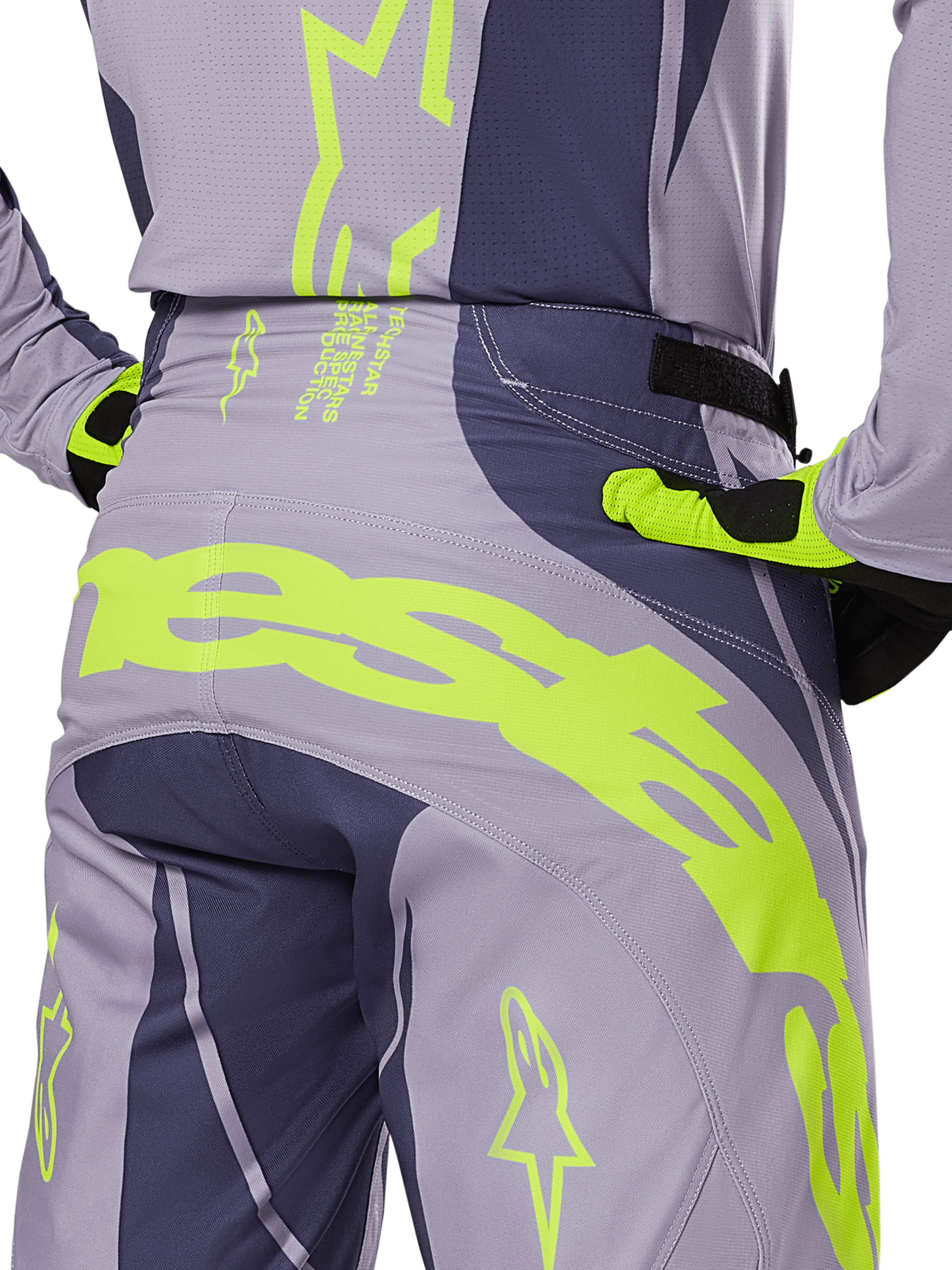 Alpinestars 2025 Techstar Dreem Pants, Motocross Pants, Gray and Dark Gray with bright Lime Green accents, rear detail view showing matching jersey and gloves, large fluorescent yellow branding across the seat, athletic race fit for off-road riding
