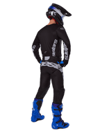 Alpinestars 2025 Racer Graphite Pants, Motocross Pants, Black and Gray, back view of a rider in a full gear set with a matching jersey and bright blue boots, featuring large gray branding on the seat and an ergonomic pre-curved design for off-road racing.