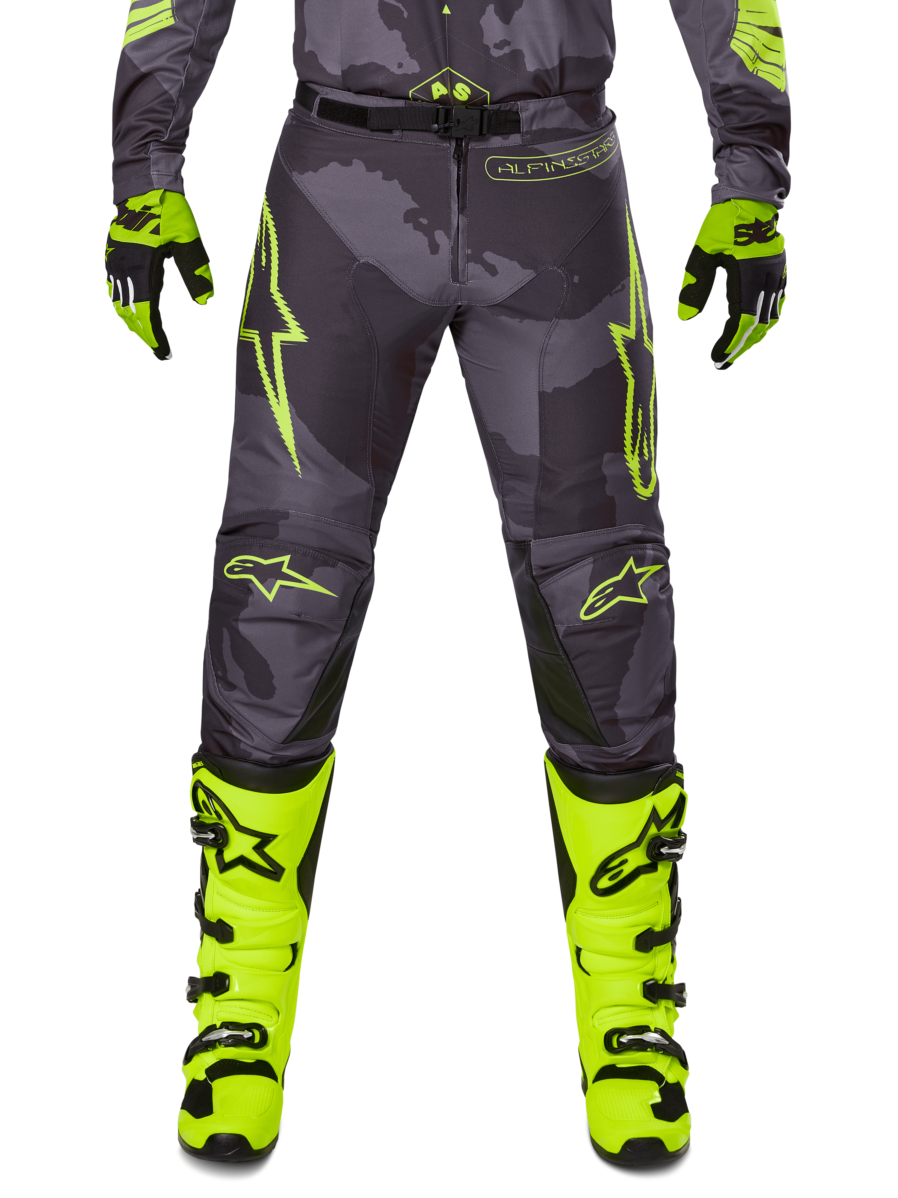 Alpinestars 2025 Racer Hollow Pants, motorcykelbyxor för motocross, mörkgrå med neongula detaljer, gula stjärnlogotyper, kombinerad med neongula stövlar och svarta handskar, skyddande sportdesign