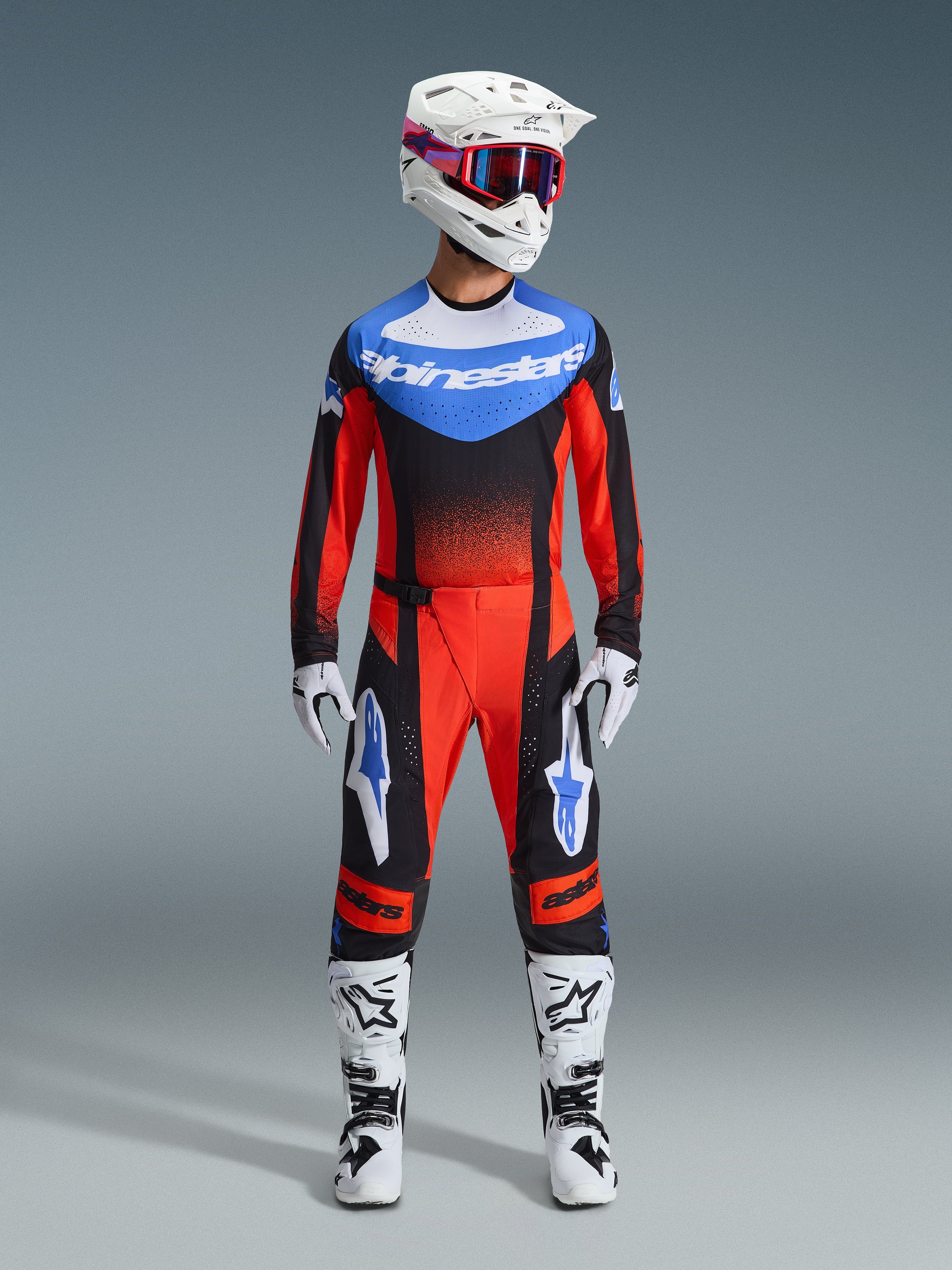 Alpinestars 2026 Techstar Knif Gear Set, Motocross Racing Gear, Red and Black with Blue Accents, complete MX outfit including jersey, pants, white helmet with pink and blue graphics, white gloves, and white boots, professional off-road racing equipment