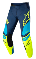 Alpinestars Techstar Factory-byxor, motocrossbyxor för racing, mörkblå, neongula och ljusblå, med svarta innerpaneler vid knäna, gul stjärnlogotyp på låret, "ONE GOAL ONE VISION"-grafik och perforerade ventilationszoner för högpresterande terrängkörning