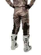 Alpinestars 2024 Racer Tactical Pants, Motocross Pants, Military Green Camo Brown, back view showing camouflage pattern and black breathable stretch panels on the lower legs, worn with white motocross boots, durable technical gear for off-road riding