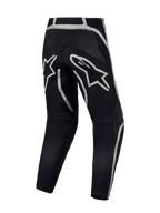 Alpinestars Fluid Apex V2 byxor, svarta och silver motocrossbyxor sedda bakifrån med förstärkt säte och A-star-logotyp.