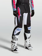 Alpinestars Fluid Drag byxor, herr-motocrossbyxor i svart och vitt med neonröda och ljusblå detaljer.