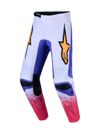 Alpinestars Fluid Drag byxor, vita och blåa motocrossbyxor med rosa spräcklig grafik och gul stjärnlogotyp, för terrängkörning.