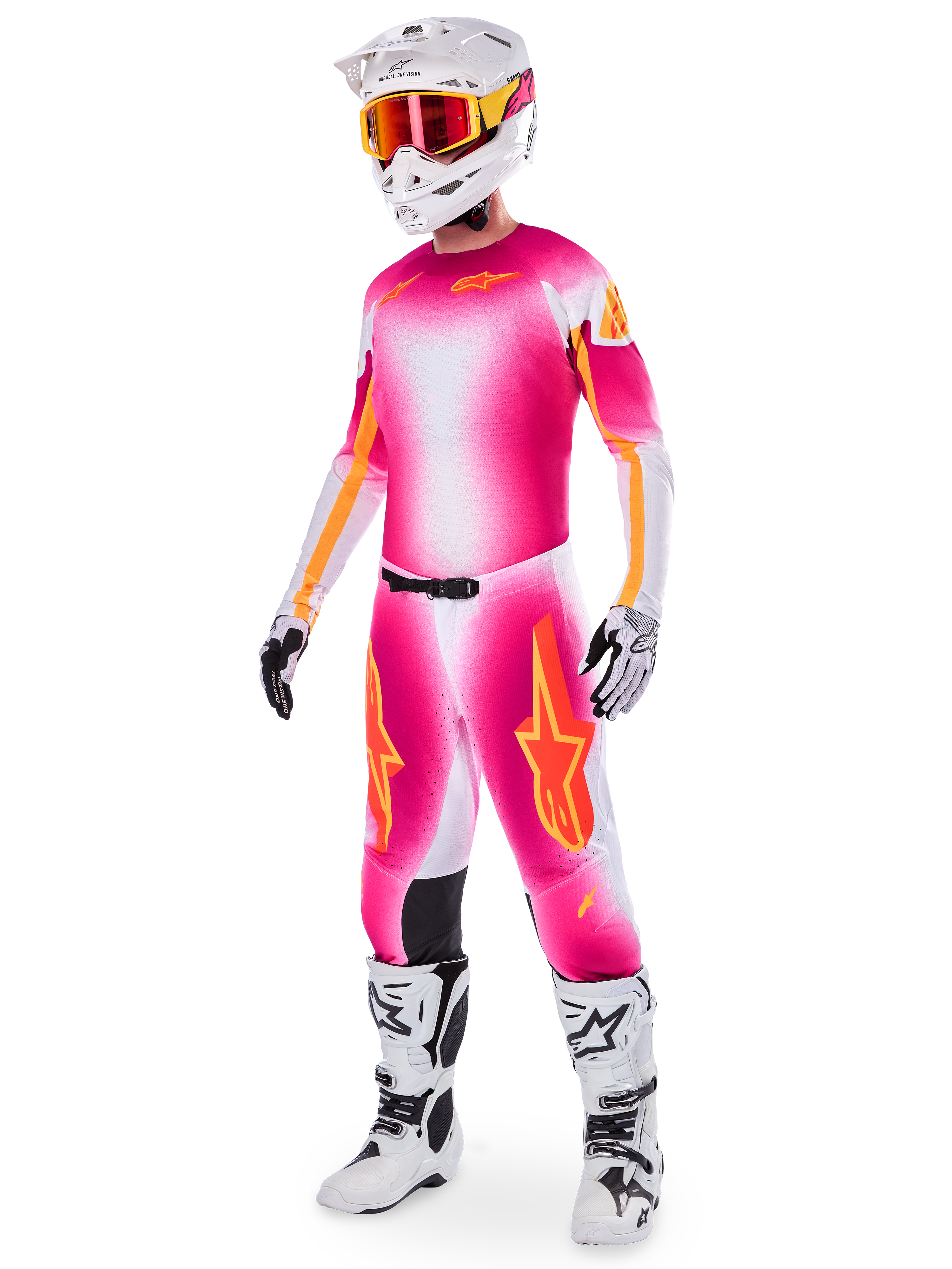 Motocrossförare i Alpinestars Supertech AFD MIG Limited Edition-ställ, tröja och byxor med färgtoning i neonrosa, vitt och orange, vit hjälm med orangea goggles, vita och svarta stövlar, professionell motocrossutrustning
