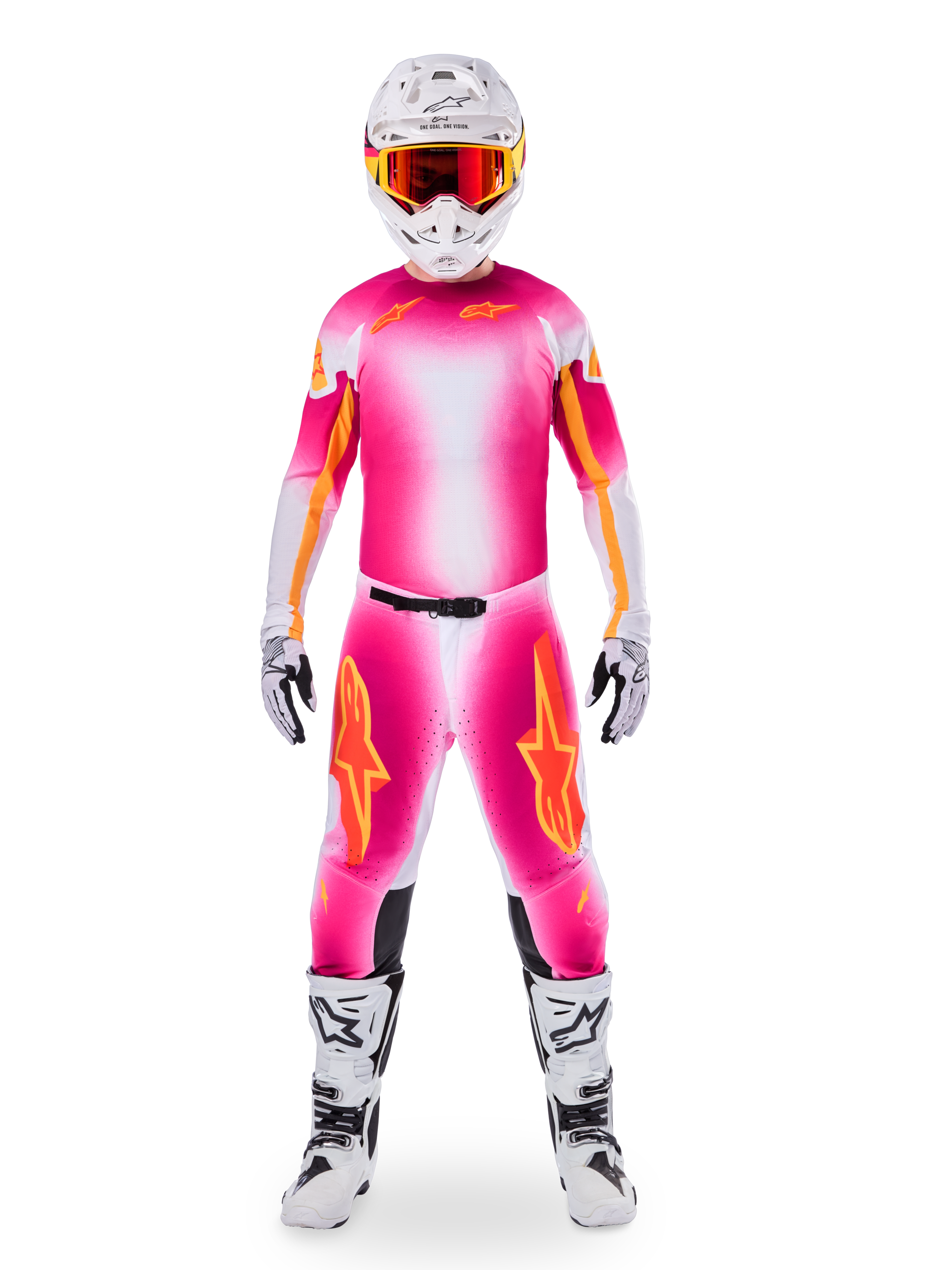 Motocrossförare iförd Alpinestars Limited Edition Supertech AFD MIG-utrustning, livfullt rosa fluo och vit tröja och byxor med tonad färgövergång och orange logotyper, vit hjälm med röda goggles, vita och svarta stövlar och handskar, koordinerad professionell racingoutfit