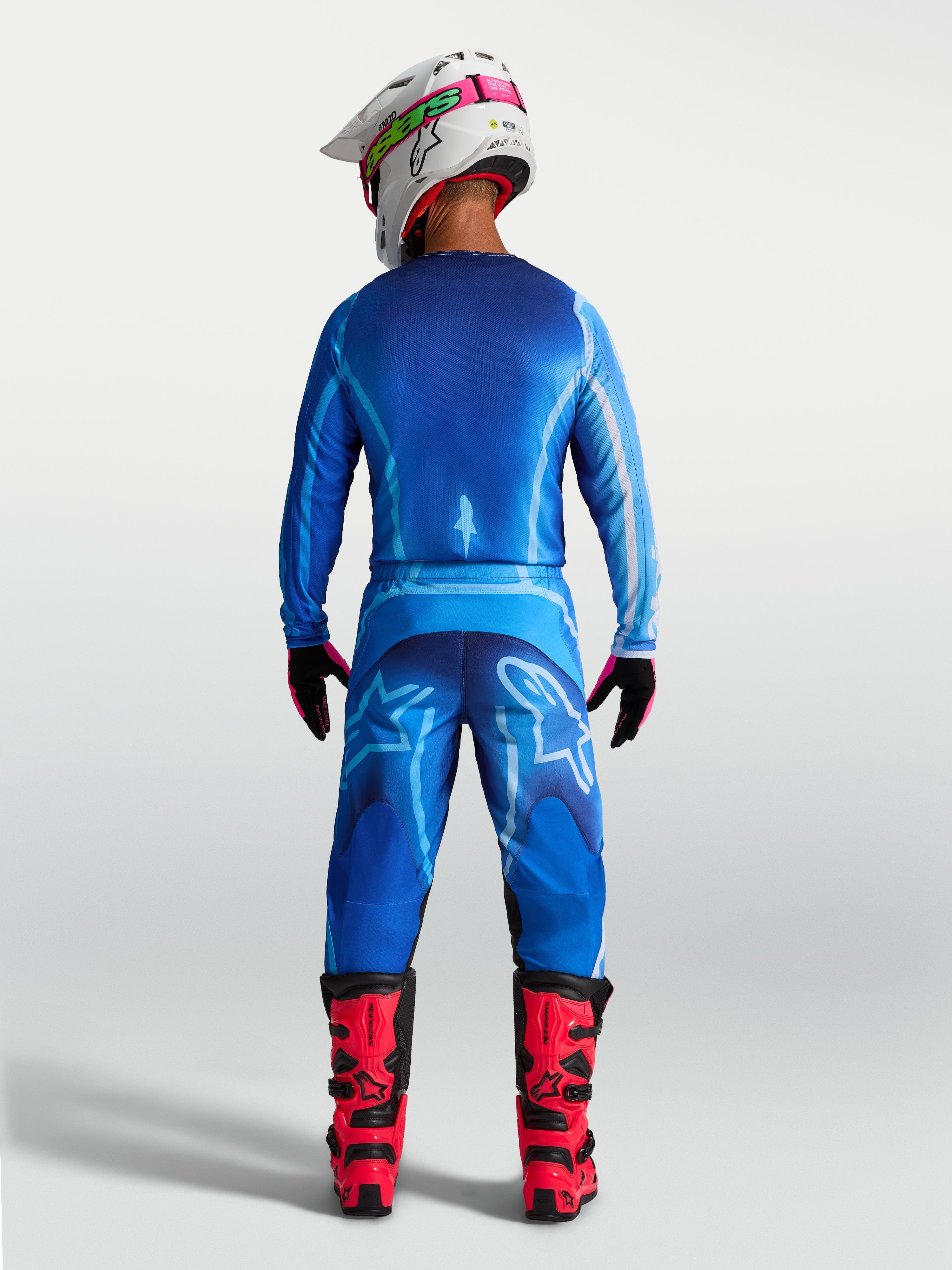 Alpinestars Fluid Kepler byxor, blå herrmotocrossbyxor, vy bakifrån som visar ergonomisk passform i hållbart polytyg.
