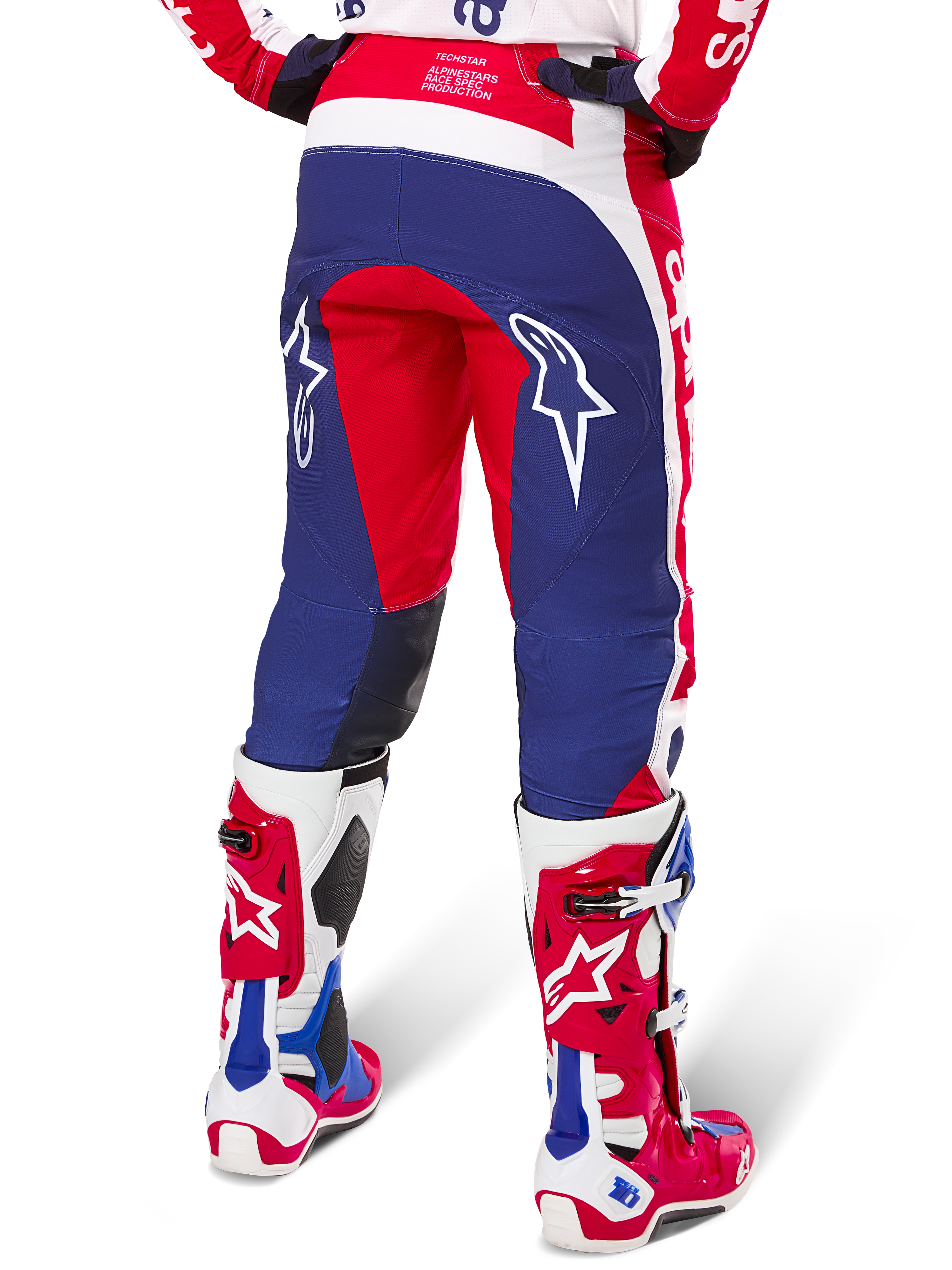 Alpinestars Limited Edition Techstar Fortitude Pants, Motocross Pants, Red White and Blue, back view worn with matching red and white boots, featuring white star logos on the thighs, durable multi-panel design for professional off-road racing.