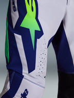 Alpinestars 2026 Supertech Vista byxor, motocrossbyxor, ljusgrå, neongula och blå, närbild på lår- och knäområdet med en framträdande neongrön stjärnlogotyp på en blå panel, laserskurna perforeringar för ventilation och svarta innerpaneler vid knäna