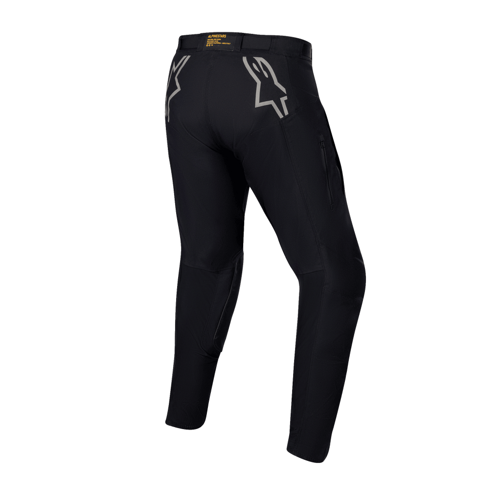Alpinestars Techdura Pants, Black Enduro and Off-Road Pants, rear view featuring grey star logos on the hips, yellow branding on the back waistband, rugged stretch polyamide material with a durable design for motorcycle riding