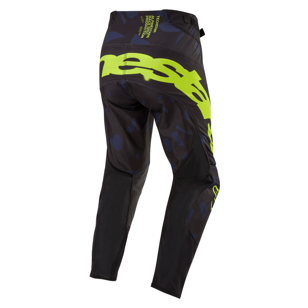 Alpinestars 2024 Techstar Rantera-byxor, motocrossbyxor, svarta, marinblå och gul fluo, sedda bakifrån med framträdande logotyp i gul fluo på sätet, marinblå mönstrade paneler och tekniskt svart tyg för prestanda vid terrängkörning
