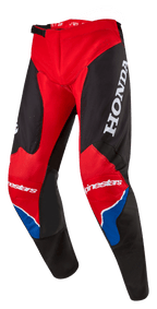 Alpinestars Honda Racer Iconic-byxor, motocrossbyxor, klarröda, svarta och vita med blå detaljer, stor vit HONDA-logotyp på låret, Alpinestars-logotyper på knäna, ergonomisk förböjd benkonstruktion och justerbart spännlås i midjan