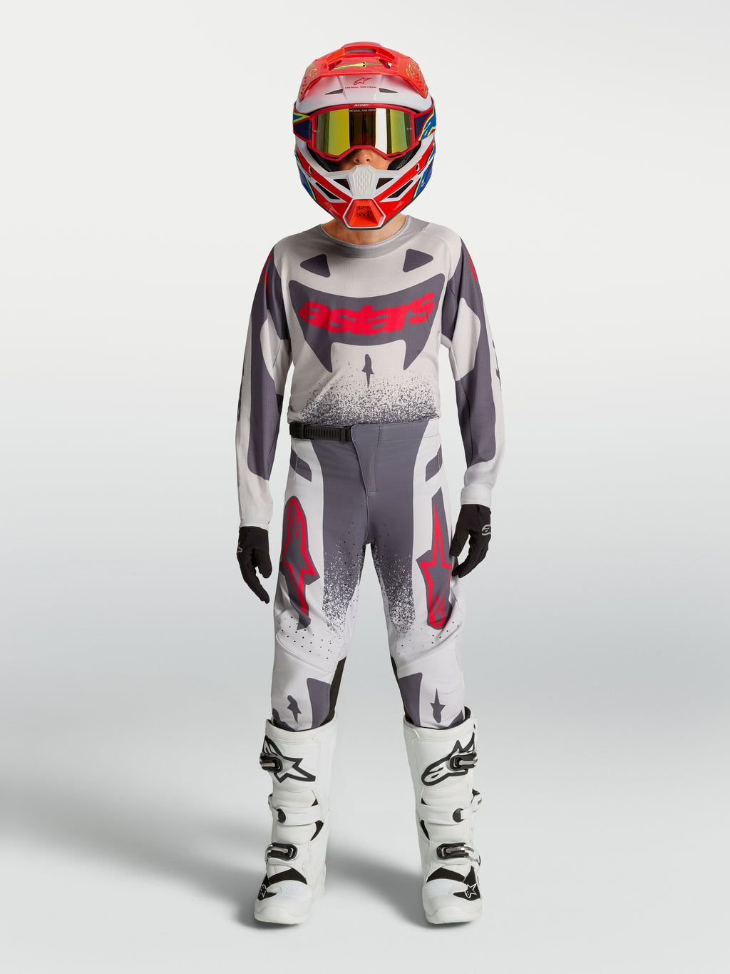 Alpinestars 2027 Supertech Swan ungdomsbyxor, motocross-utrustning, grå och röd fluo, atletisk racingpassform för unga förare.