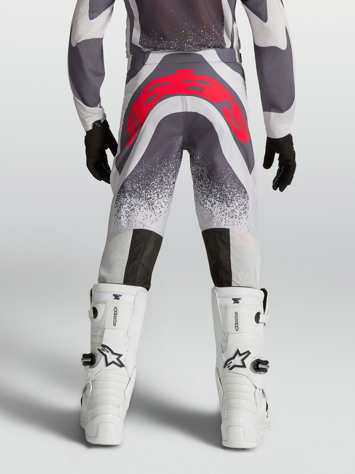 Alpinestars Youth Supertech Swan Motocross Pants in Gray and Red Fluo, rear view showing athletic fit and reinforced seat.