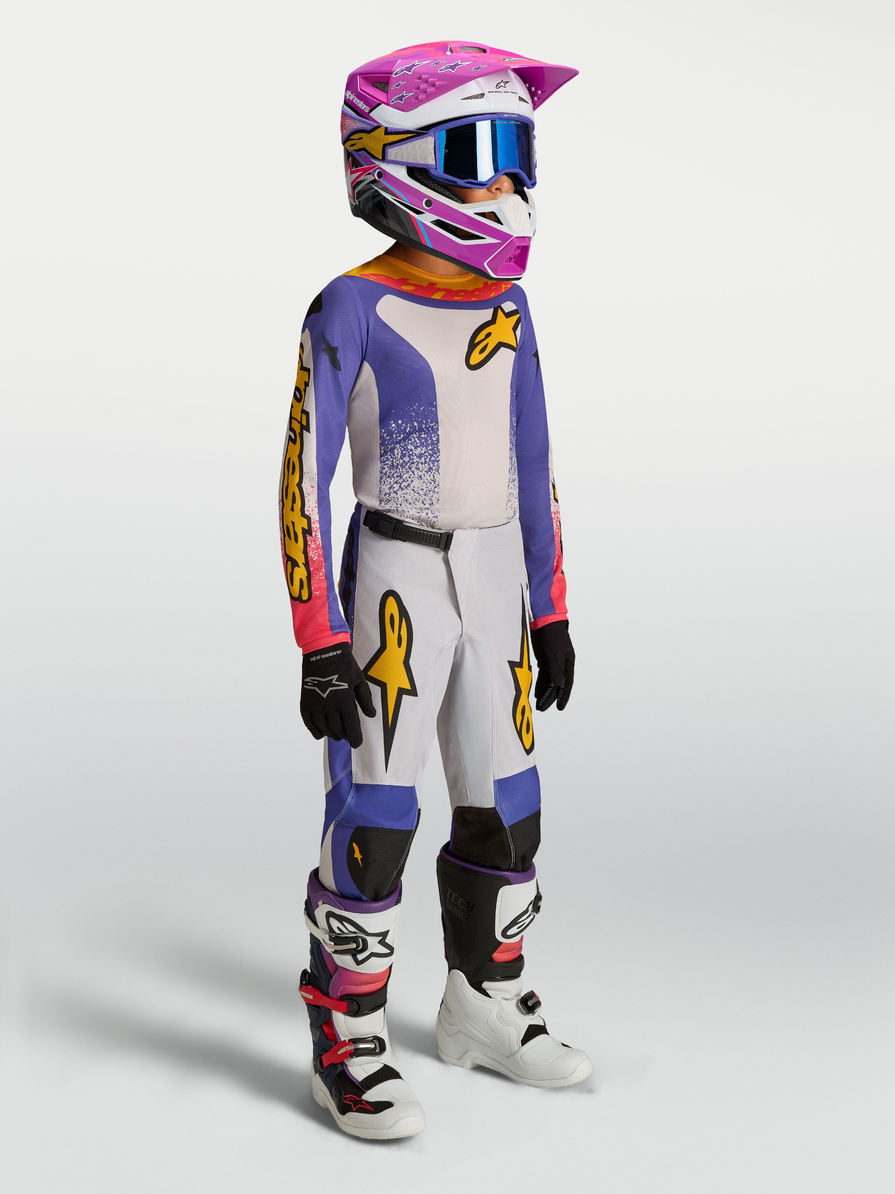 Alpinestars 2027 Ungdom Fluid Drag byxor, blåa och guldiga motocrossbyxor för barn, slitstark textil och ergonomisk passform.