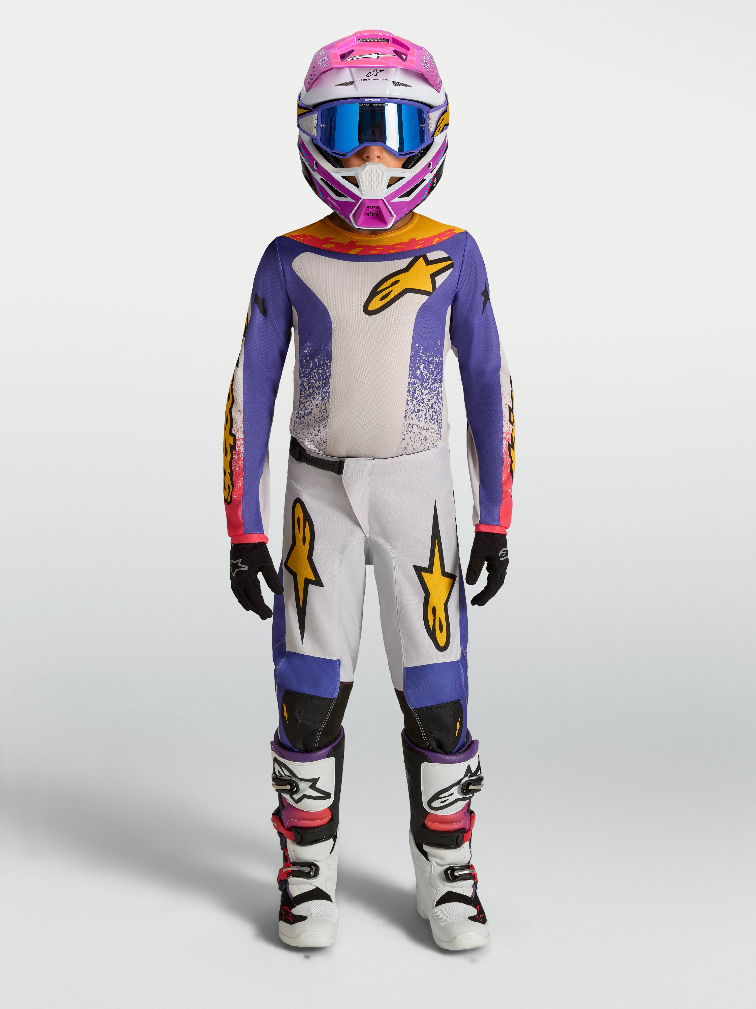 Alpinestars Ungdom Fluid Drag byxor, lila och vit motocrossutrustning för terrängkörning med gulddetaljer.